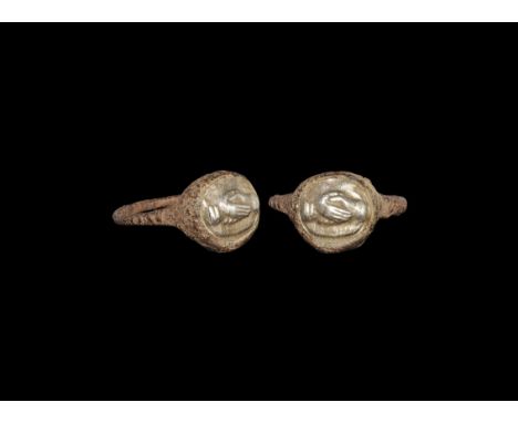 Roman Iron Ring with Silver Clasped Hands Intaglio 2nd century AD. A round-section iron hoop and domed discoid bezel, silver 