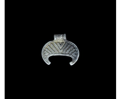 Viking Silver-Gilt Filigree Lunate Pendant 8th century AD. A crescentic plaque with ribbed loop above, surface divided into p
