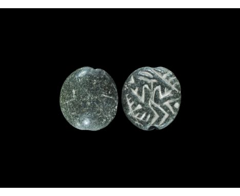 Western Asiatic Serpentine Stamp Seal with Zoomorphs 4th-3rd millennium BC. A carved stone D-section stamp seal with incised 