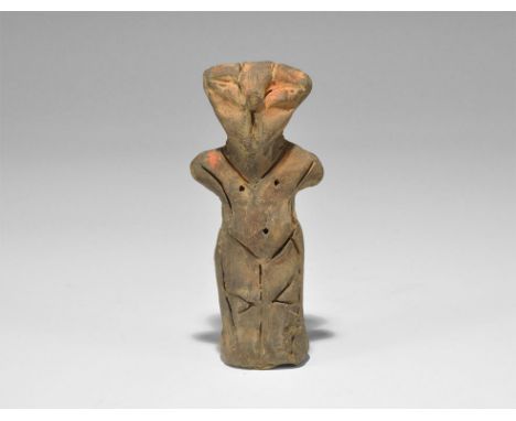 Stone Age Vin?a Ceramic Figure Neolithic, 5000-4000 BC. A terracotta robed figure with stub arms, pinched facial features; im