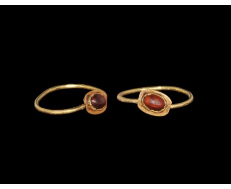 Roman Gold Ring with Cabochon Garnet 1st century AD. A plain round-section hoop supporting a discoid plaque with inset caboch