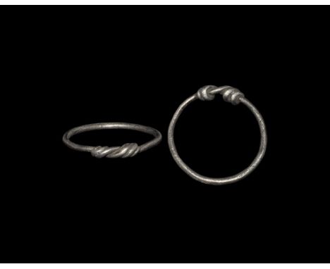Anglo-Saxon Silver Ring with Expanding Bezel 6th-7th century AD. A round-section hoop with ends coiled over the shank. 1.40 g
