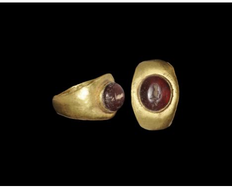 Roman Gold and Garnet Ring with Flame Intaglio 1st-2nd century AD. A flat-section hoop with expanding shoulders, broad plaque