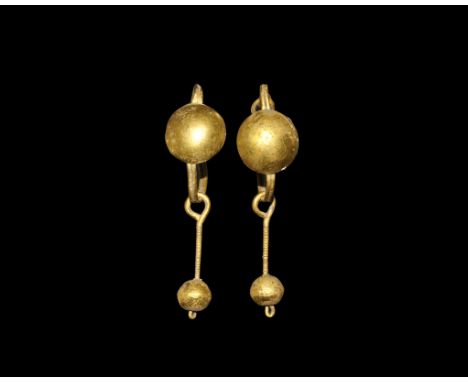Roman Gold Earring Pair with Sphere Drops 2nd century AD. A matched pair of earrings, each a wire hoop with coiled closure, h