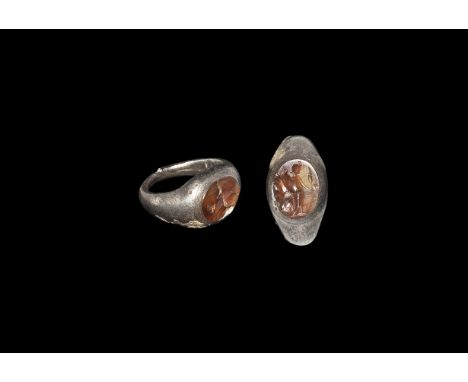 Roman Silver and Carnelian Ring with Fortuna 2nd century AD. A D-section hoop expanding to a broad plaque with inset carnelia