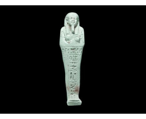 Egyptian Glazed Composition Hieroglyphic Shabti Late Period, 664-332 BC. A pale blue shabti with tripartite wig and false bea