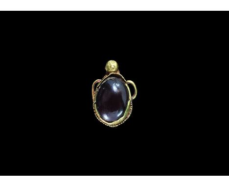 Roman Gold Teardrop Pendant with Garnet 3rd-4th century AD. A discoid plaque with granulated border, inset cabochon garnet, k