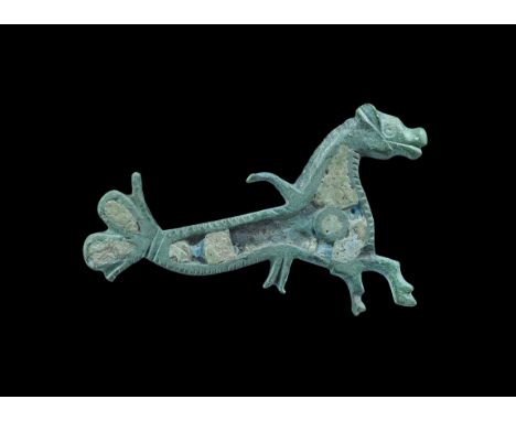 Roman Enamelled Bronze Hippocampus Brooch 2nd century AD. A cast plate brooch of a hippocampus with champ levé enamel cells t