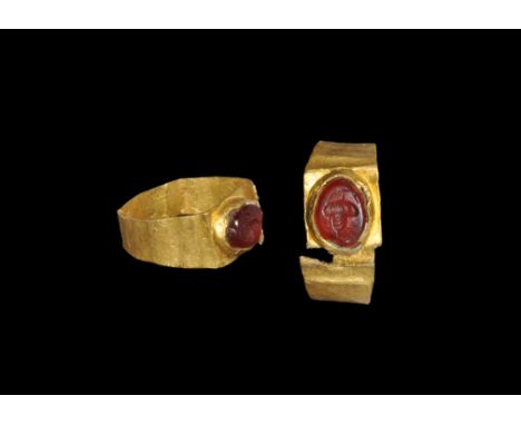 Roman Gold and Garnet Ring with Acorn Intaglio 3rd century AD. A flat-section hoop with flat plaque, inset garnet cloison wit