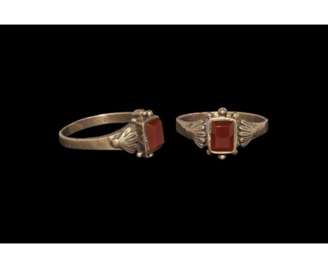 Post Medieval Gold Dress Ring 18th century AD. A flat-section hoop with applied scallop plaques to the shoulders, rectangular