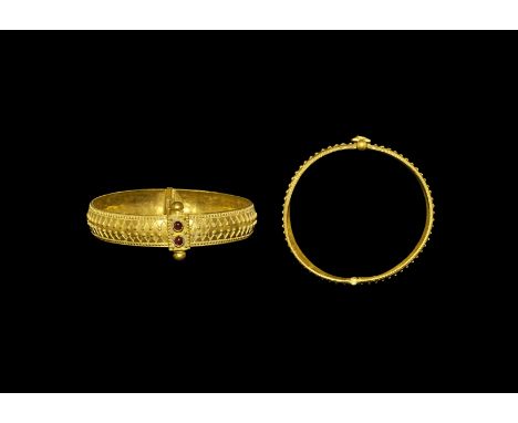 Byzantine Gold Hinge Bangle with Garnets 6th-8th century AD. A hinged bangle with pin and loop closure; the hoop concave in s