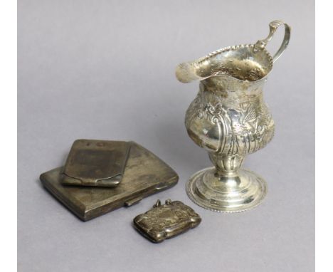 A George III silver cream jug of inverted pear shape, with embossed decoration of a farmyard scene, London 1821 by Thos. Stre