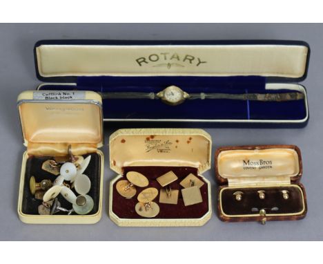 A pair of 9ct. gold cuff-links, the oval panels with engraved masonic emblems  (5.4gm); another pair with square engine-turne