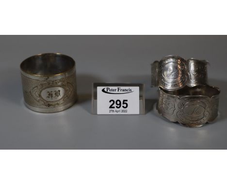 Pair of white metal napkin rings marked H & M, together with another engine turned napkin ring.(B. P. 21% + VAT) 