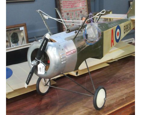 Radio controlled scale flying model of a WWI period sopwith pup having single cylinder petrol engine, the wings detached. Ove