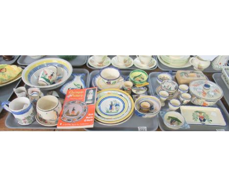 Three trays of Quimper ware pottery items decorated with figures, flowers and foliage to include butter dish and cover, mugs,