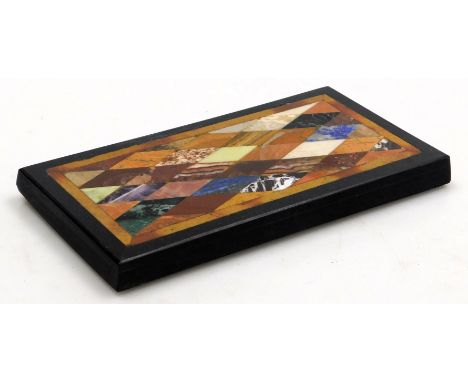 A 19thC Grand Tour Pietra Dura specimen paperweight, inset with agates, lapis lazuli, blue john and other stones, within a sl