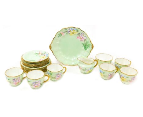 A Royal Crown Derby porcelain part tea service, outside painted with flowers, printed, and artist's painted marks, comprising