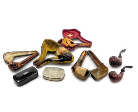 Six Victorian and later pipes, including a pipe carved with a nubian boy, further pipe carved with a cherub, three cased, tog