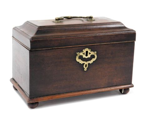 A George III mahogany tea caddy, with a brass carrying handle, the hinged lid opening to reveal three compartments, raised on