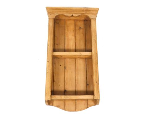 A Victorian pine wall hanging shelf, with an outswept pediment, above two shelves, 86cm high, 45cm wide, 16cm deep.