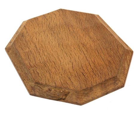 A Robert Thompson of Kilburn 'Mouseman' bread board, of octagonal form, carved to the side with a mouse, 30cm wide, 25cm deep