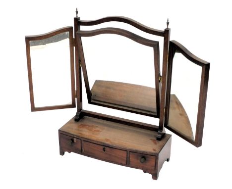 A George III mahogany toilet mirror, with a triptych mirror, over a bow fronted base with one long and two short drawers, rai