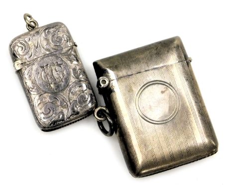 A George V silver vesta case, with engine turned decoration, vacant circular reserve, Birmingham 1911, together with a furthe