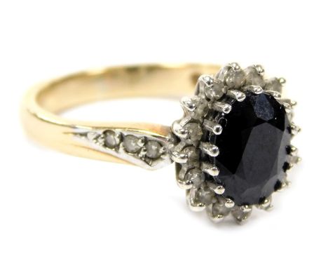 A 9ct gold sapphire and diamond ring, the oval cut sapphire in a surround of diamonds, with diamond set shoulders, size O, 3.