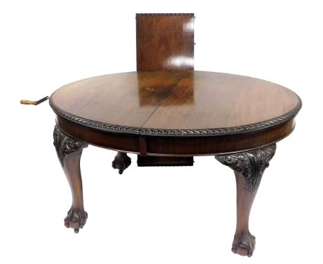 A late Victorian mahogany Chippendale style wind out dining table, with one additional leaf, the top with a gadrooned edge, r