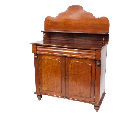 A mid 19thC Australian cedar chiffonier, with a shaped back and single shelf, raised on turned supports, over a cushion drawe