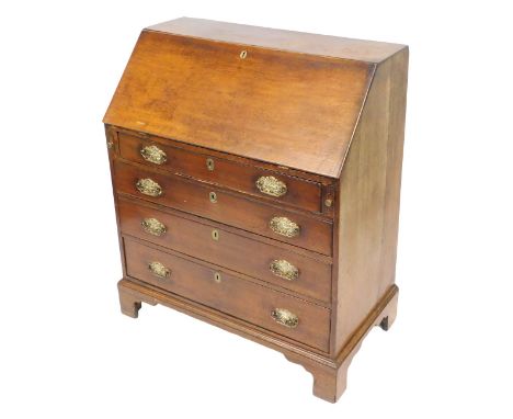 A George III oak bureau, the fall flap opening to reveal a central door flanked by two recesses and six drawers, over four lo