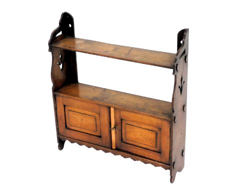 Victorian oak wall hanging shelves, with carved sides, the shelf with two cupboard doors enclosing a further shelf, 61cm high