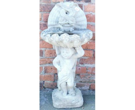 A concrete birdbath, of shell form, with an entwined dolphin back, raised on a figure of a putti, above a square cushion base