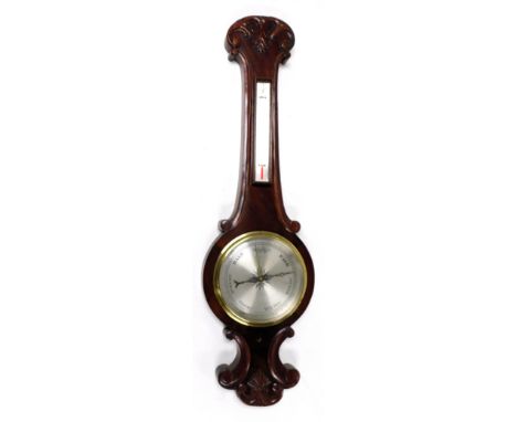 A Victorian mahogany wheel barometer, with thermometer, the case with foliate carved decoration, 92cm high. 