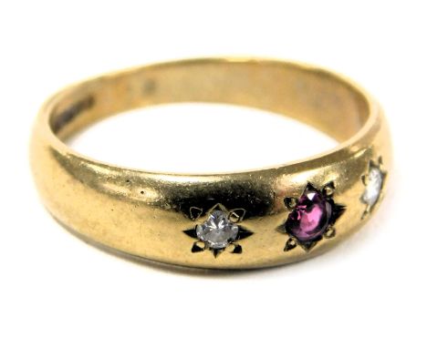 A 9ct gold ruby and diamond three stone gypsy ring, in a rub over setting, size L, 2.7g.