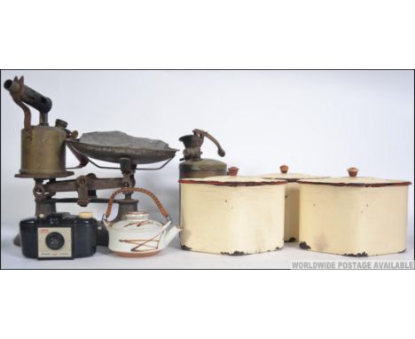 A vintage enamel canister two tone kitchen set, possibly French together with a set of brass scales and blow torches