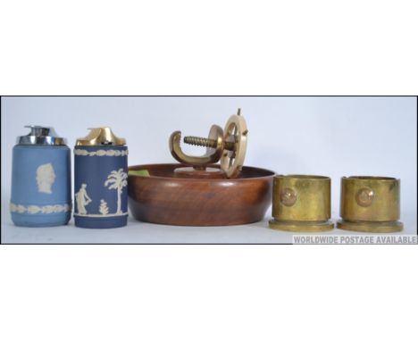 A collection of table items to include two Wedgwood table lighters, a nautical inspired nut cracker and a pair of trench art 