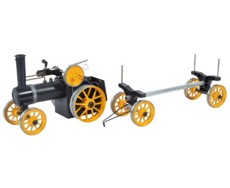 An original vintage Mamod made live steam traction engine TWK1 and matching log trailer. Yellow and black colourway, with sol
