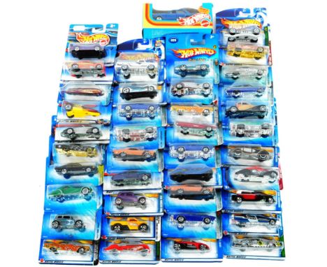 A large collection of x40 assorted carded Mattell made Hot Wheels diecast model cars to include No. 067 Dragon Wheels Lincoln
