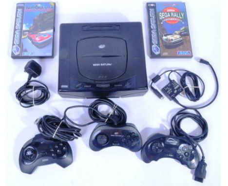 An original vintage Sega made Sega Saturn video computer games console and games comprising the console, 2x official controll