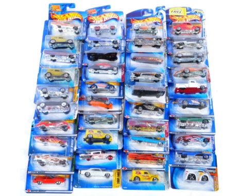A large collection of x40 assorted carded Mattell made Hot Wheels diecast model cars to include No. 115 Cadillac 1935, 058 Ch