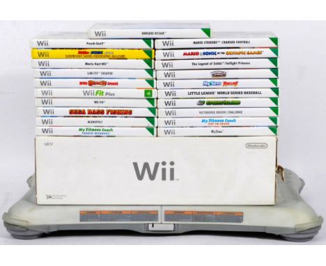 An original Nintendo made Wii video game computer console, games and accessories comprising a boxed Nintendo Wii, Wii Fit, Pu