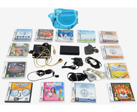 An original Nintendo made DS portable handheld video computer games console and games. The DS in black with Sims 2 Castaway, 
