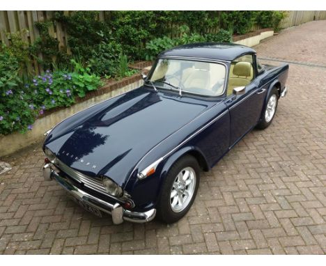 A 1966 Triumph TR4A, registration number GRW 474D, blue. The Giovanni Michelotti designed TR4, became available in 1965 and r