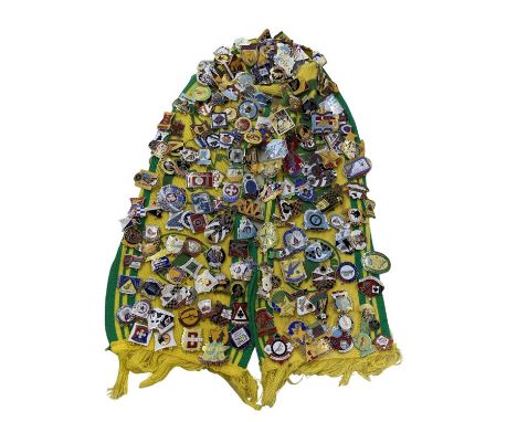 A very large collection of vintage enamel Speedway badges, attached to a Sunshine Speedway scarf.