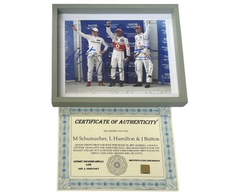 F1 interest: An 8x10" colour photograph bearing the signatures of Michael Schumacher (blue ink), Lewis Hamilton (black ink) a