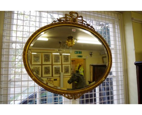 An antique gilt framed oval wall mirror,&nbsp;88cm wide.&nbsp; 