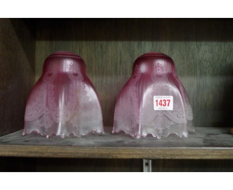 A pair of cranberry glass light shades, 14cm high.&nbsp;&nbsp; 