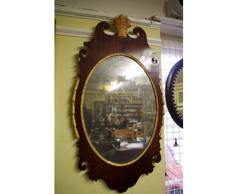 An 18th century mahogany and parcel gilt framed pier mirror,&nbsp;with carved detail and original plate, 100 x 53cm.&nbsp; 